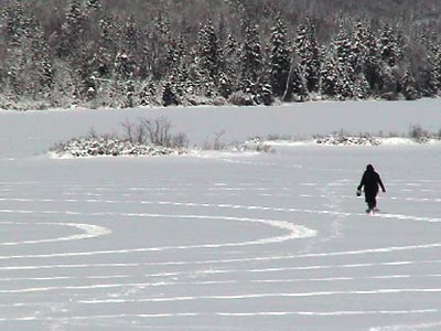 figure walking a circle on frozen lake