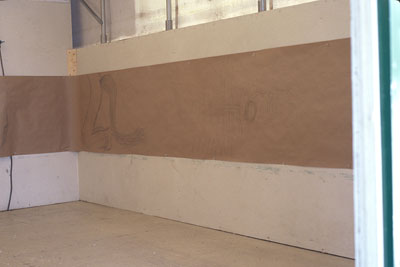 drawings in a strip along wall of tent