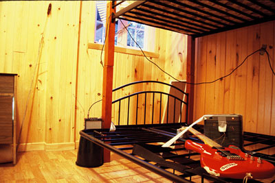 sound installation including red guitar on bunk bed