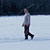 whitehead walking across frozen lake with porcupine stick